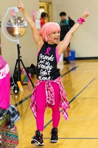 Photo of a triumphant Tomoko in pink Zumba clothing
